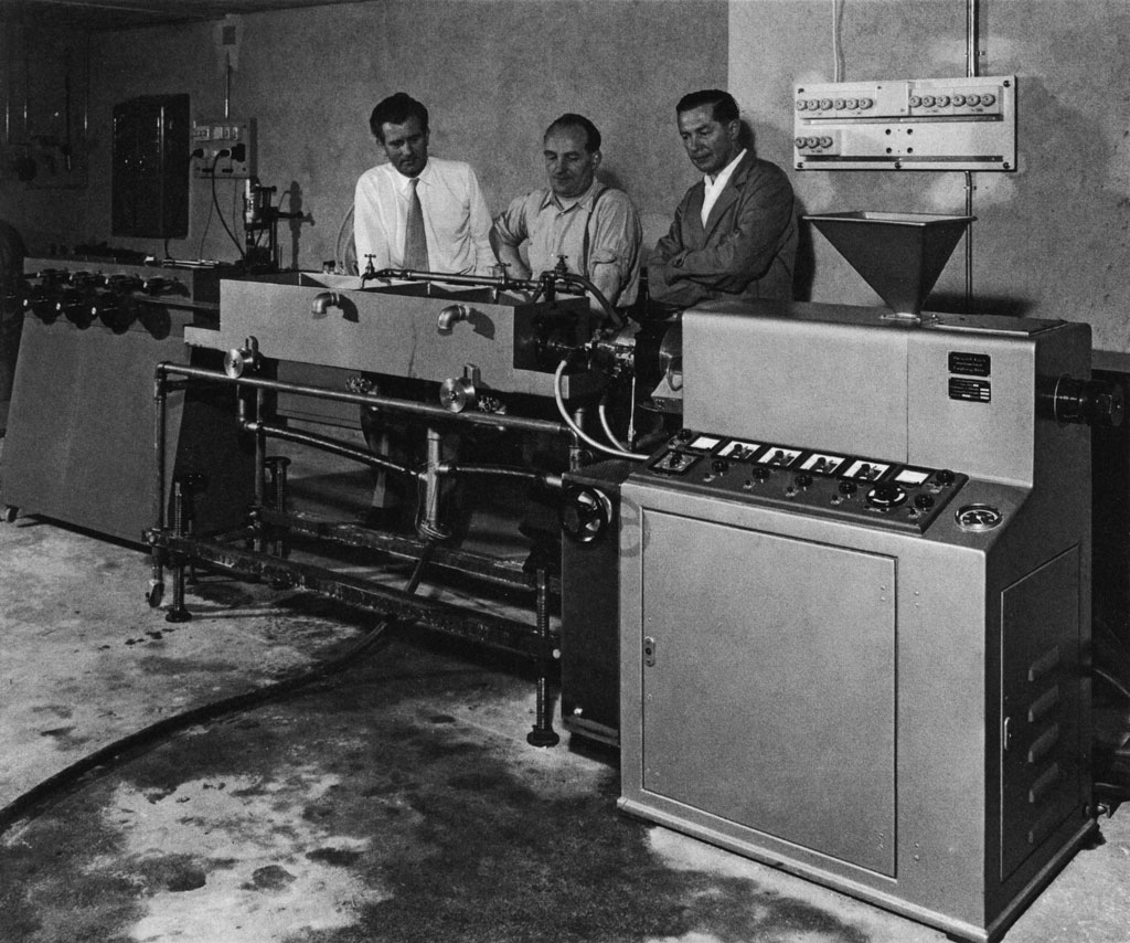 Company's founders in a garage with the first machine